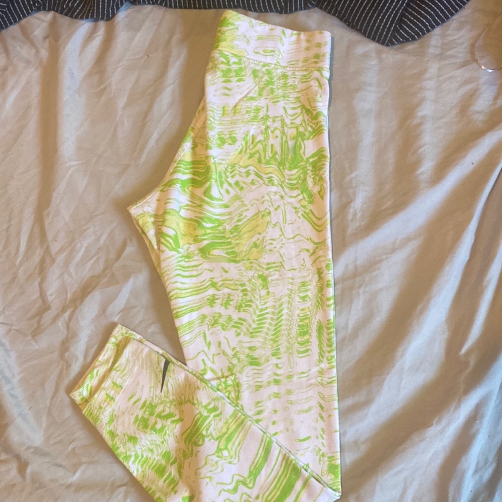 Green, white, and yellow Nike stretch pants.